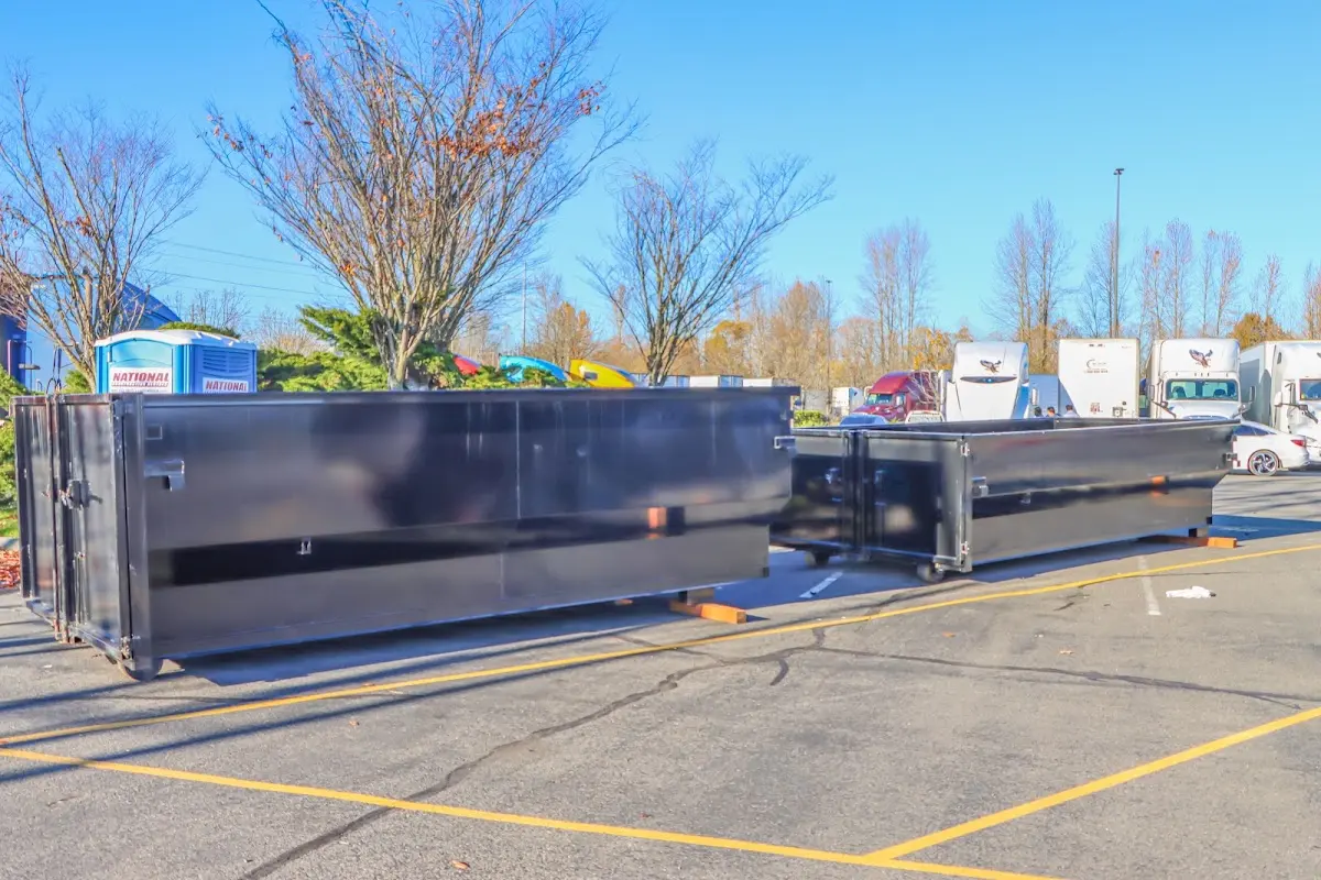 Professional dumpster rental service with roll-off container on residential driveway in Owego